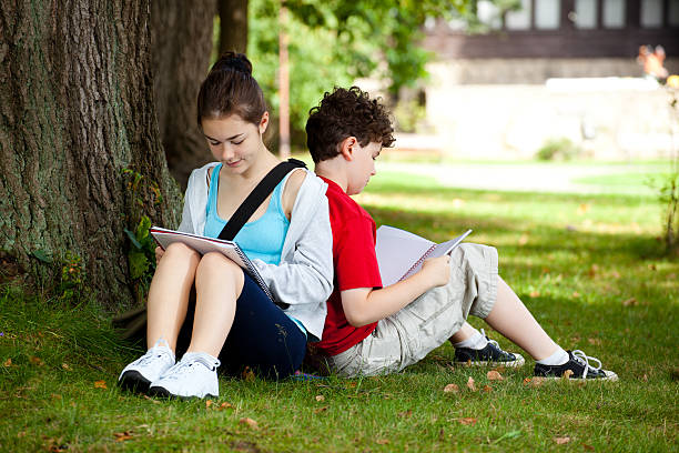 istock Girl and boy learning in park 139512630