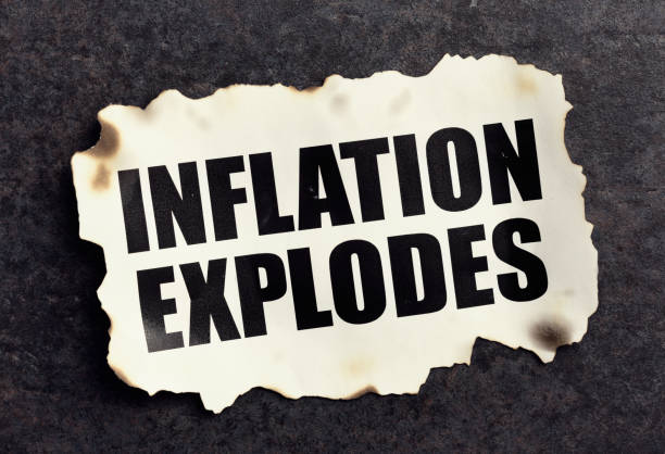 istock Inflation Explodes, says torn newspaper headline cutting with burnt edges 1395126305