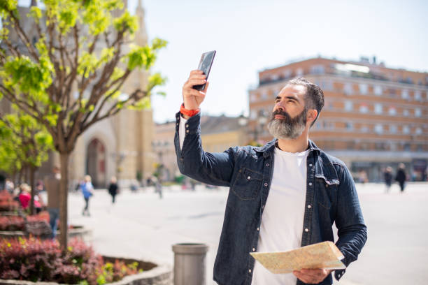 istock Mid adult handsome man on a journey 1395126319