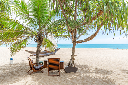 Outdoor seating set on a beautiful sandy beach near Tangalle, Sri Lanka