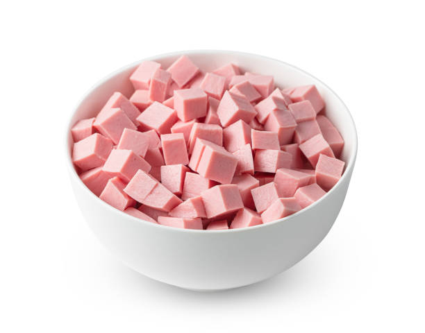 istock Boiled sausage cut into cubes in a cup is isolated on a white background. 1395127426