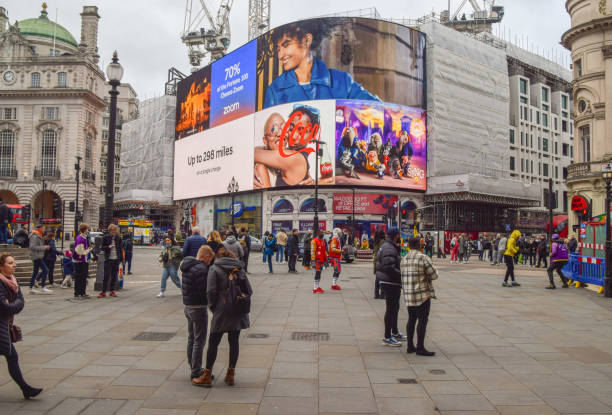 Piccadilly Circus daytime view, London, UK London, UK - January 29 2022: busy Piccadilly Circus, daytime view soho billboard stock pictures, royalty-free photos & images