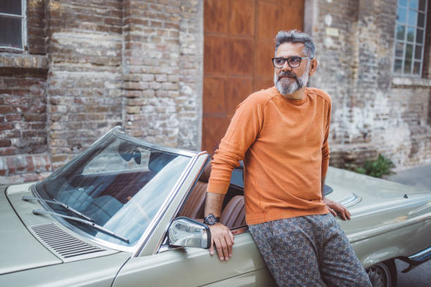 istock Man standing next to his vintage car 1395131774