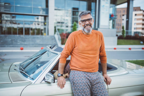 istock Man standing next to his vintage car 1395131786