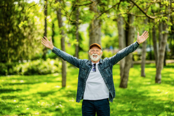 istock Ecstatic senior man enjoying a beautiful spring day in nature. 1395132447