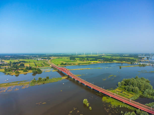 istock Hanzeboog train bridge over the river IJssel with high water level 1395132988