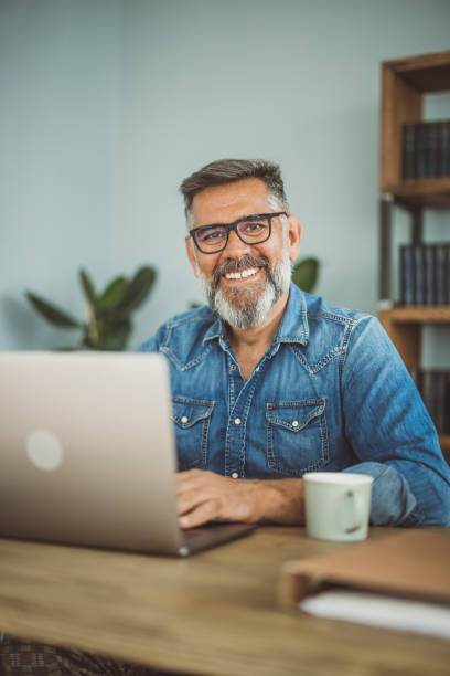 istock Mature man working from home office 1395133000