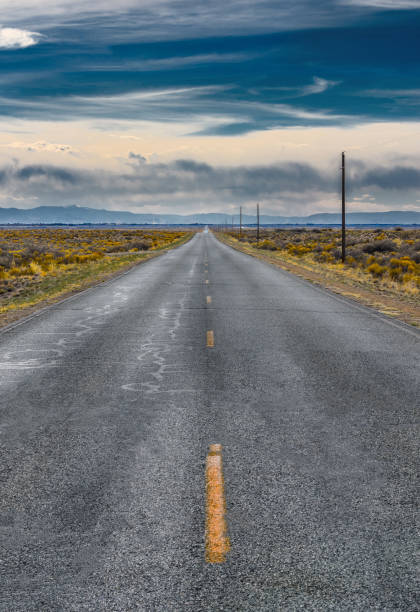 istock The road intersects the plain and rests against the mountains. 1395133039