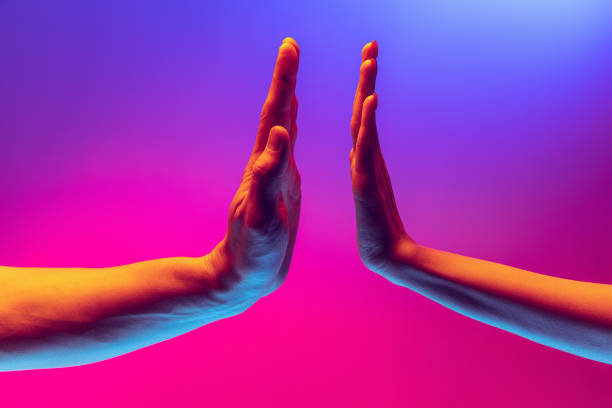 istock Pray for peace. Human hands gesturing on gradient blue and purple background in neon. Concept of human rights, social issues, gathering. 1395134865
