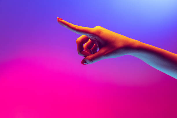 istock Human hand gesturing isolated on gradient purple-pink background in neon light. Concept of sign language, creativity, symbolism, culture and art 1395134879