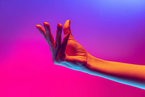 istock Human hand gesturing isolated on gradient purple-pink background in neon light. Concept of sign language, creativity, symbolism, culture and art 1395134891