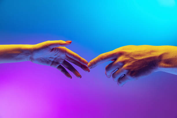 istock Two human hands touch each other isolated on gradient blue-purple background in neon light. Concept of human relation, togetherness, symbolism, culture and history 1395134915