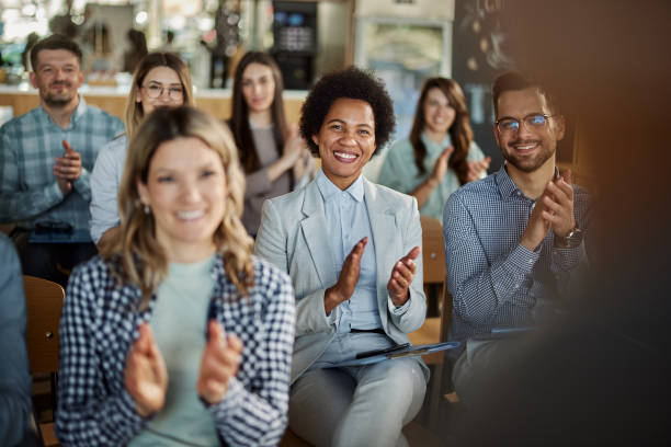 istock Happy entrepreneurs applauding on a seminar in board room. 1395136799