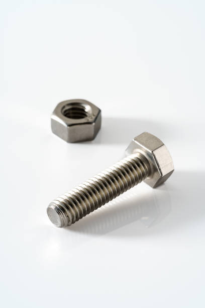 istock Stainless steel nuts and bolts closeup on white background 1395136880
