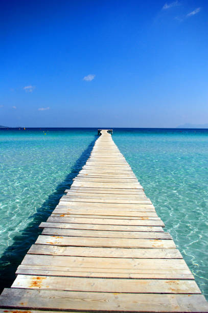 istock Jetty facing towarde the blue ocean horizon 1395137031