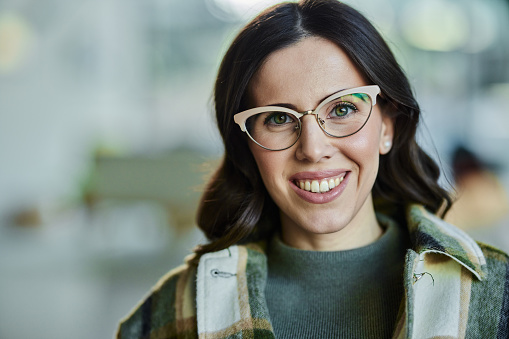 Portrait of happy woman with eyeglasses looking at camera.