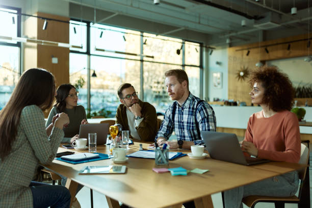 istock Young freelancers having a casual meeting in a modern office. 1395138277