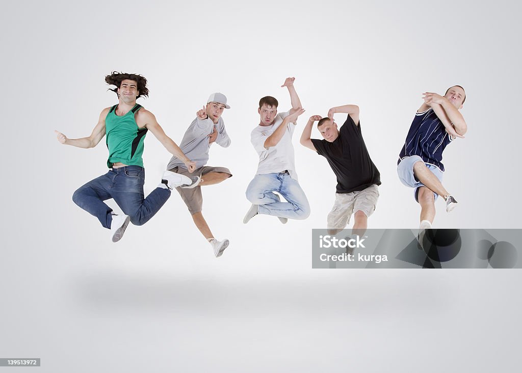 Group of young teenagers jumping over white Dancing Stock Photo
