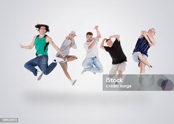 Group Of Young Teenagers Jumping Over White Stock Photo - Download Image Now - Dancing, Hip Hop Music, Boys