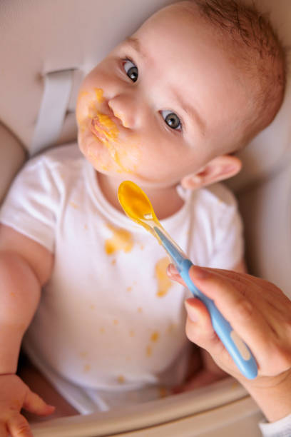 istock Baby refuses food while mother is feeding him 1395140687