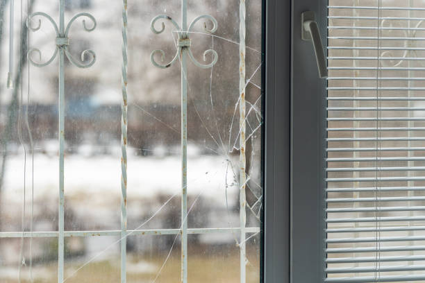 istock Glass broken by hooligans in a metal-plastic window, close-up 1395142785
