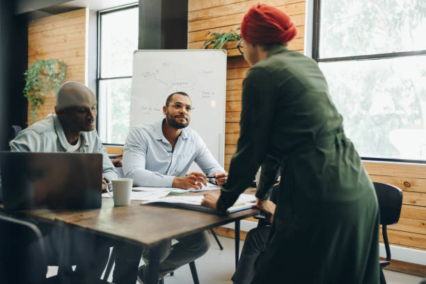 istock Modern businesspeople having a meeting in a creative office 1395144952