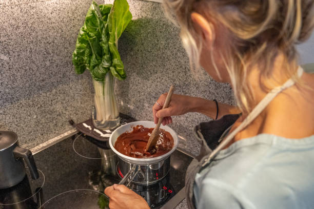 istock Woman making a chocolate cake at home 1395147253