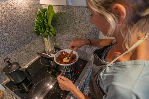 istock Woman making a chocolate cake at home 1395148347