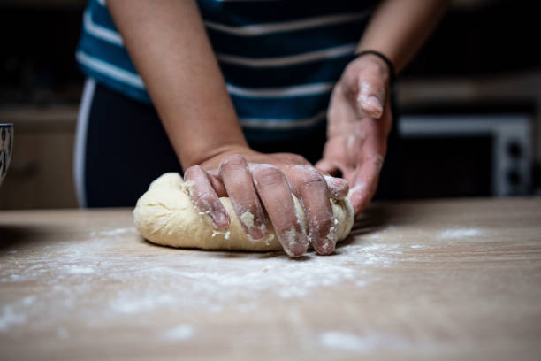 istock Young woman preparing buns at home 1395149926