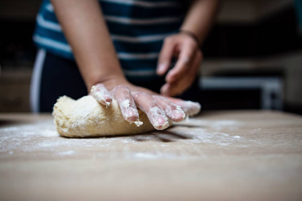 istock Young woman preparing buns at home 1395149936