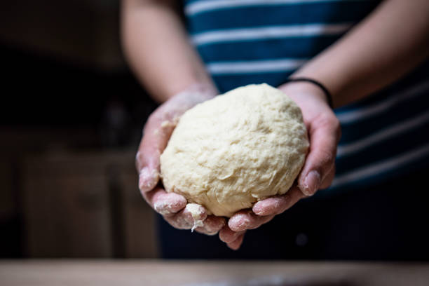 istock Young woman preparing buns at home 1395150310
