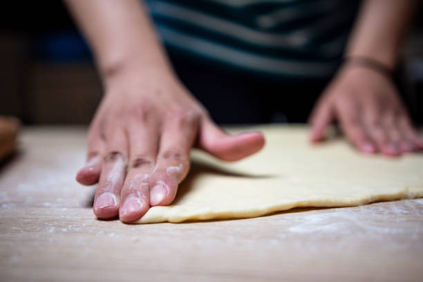 istock Young woman preparing buns at home 1395150455