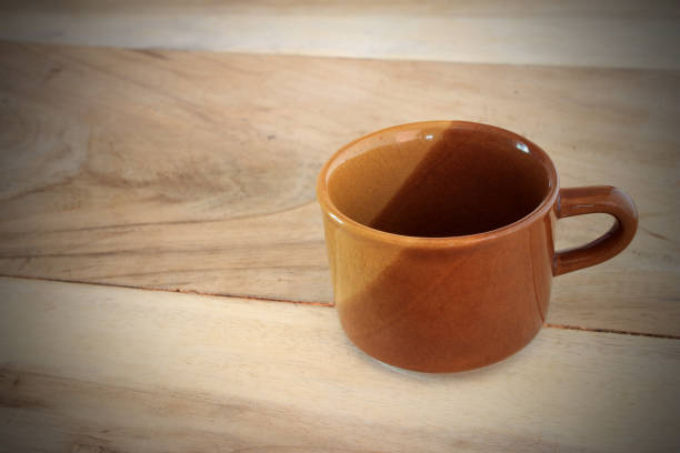 istock Coffee cup on wooden table background 1395150632