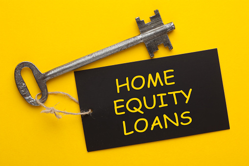 Home equity loan. Concept using an old key with a tag.
