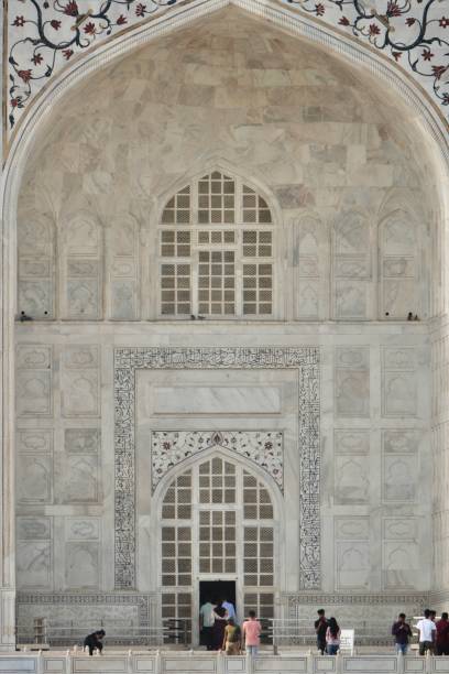 Agra, Uttar Pradesh, India - April 18, 2022 : Taj Mahal, probably the most popular tourists destinations in south-east Asia. Millions of tourists, both local and foreign, visit it every year, from very young to very old (on wheel chairs). A spell-binding marble extravaganza, also perhaps the most-clicked tourist destination in India and the world,