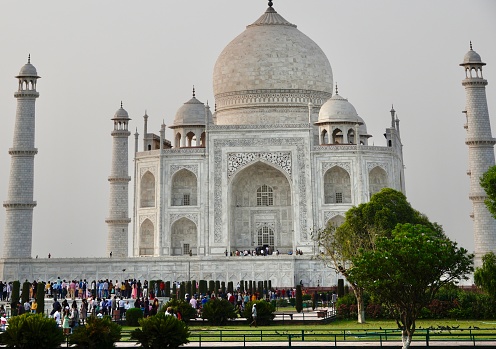Agra, Uttar Pradesh, India - April 18, 2022 : Taj Mahal, probably the most popular tourists destinations in south-east Asia. Millions of tourists, both local and foreign, visit it every year, from very young to very old (on wheel chairs). A spell-binding marble extravaganza, also perhaps the most-clicked tourist destination in India and the world,