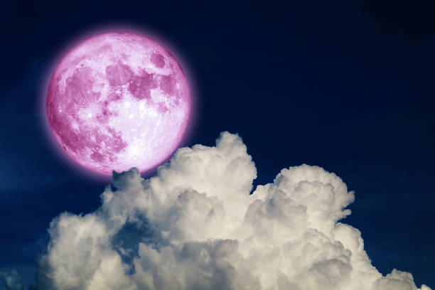 istock Full pink moon and white silhouette cloud in the night sky 1395152253