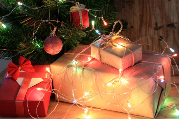 istock light celebration on christmas tree with gift box in living room 1395152257