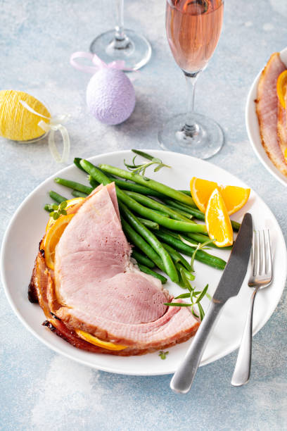 istock Easter baked ham served on a plate with green beans 1395154109