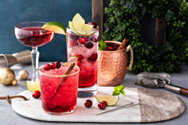 Variety of festive Christmas cocktails with cranberry and lime stock photo