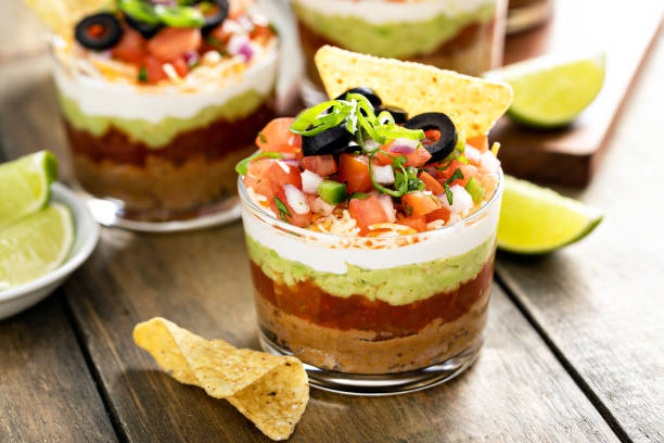 Seven layer dip in individual cups, mexican appetizer