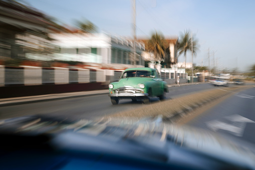 Motion blur of classic cars in Old Havana. Cuban culture. Travel in Cuba.