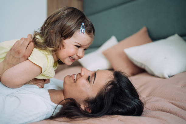 istock Affectionate mother and daughter embracing at home. 1395154800