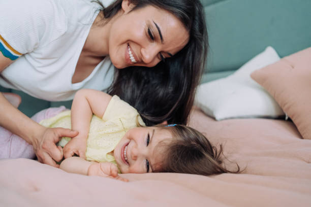 istock Affectionate mother and daughter embracing at home. 1395154801