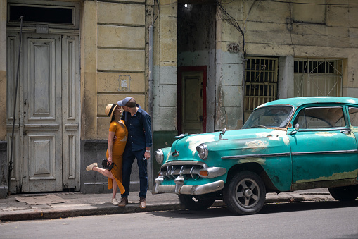 Tourists in Old Havana. Travel to Cuba. Vintage cars in Havana.