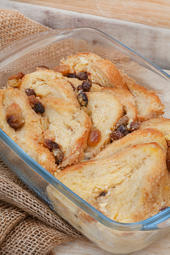 freshly baked classic bread and butter pudding with raisins on rustic surface