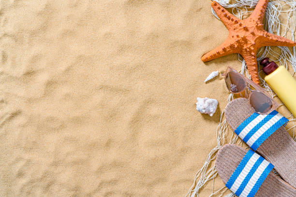 istock Summer beach holiday accessories on sand background 1395156407
