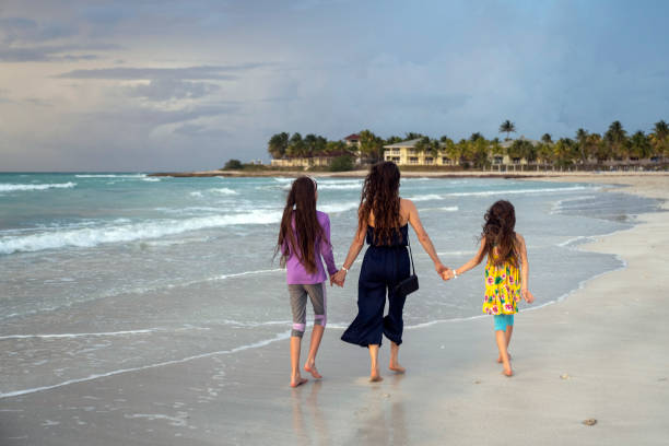 istock Mother and daughters on a tropical beach vacation 1395156457