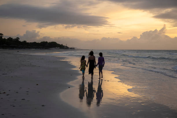 istock Mother and daughters on a tropical beach vacation 1395157207