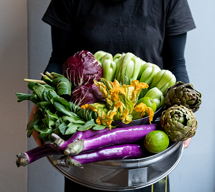 holding fresh organic vegetable